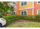 Exterior view of building with colorful stucco facade, green lawn and parking at 4207 S Dale Mabry Hwy # 2105, Tampa, FL 33611