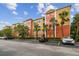 Condominium with colorful exterior paint, reserved parking, and mature landscaping at 4207 S Dale Mabry Hwy # 2105, Tampa, FL 33611