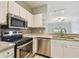 Bright kitchen featuring stainless steel appliances, granite countertops, and plenty of cabinet space at 4207 S Dale Mabry Hwy # 2105, Tampa, FL 33611