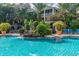 Beautiful community pool with lush landscaping, waterfalls, and comfortable lounge chairs for relaxation at 4207 S Dale Mabry Hwy # 2105, Tampa, FL 33611