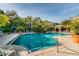 Beautiful community pool with lush landscaping, serene waterfall feature, and inviting seating for residents at 4207 S Dale Mabry Hwy # 2105, Tampa, FL 33611
