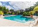 Inviting community pool with blue lounge chairs and palm trees, set against a bright building exterior at 4207 S Dale Mabry Hwy # 2105, Tampa, FL 33611