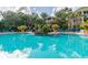 Large community pool with waterfall feature, lush landscaping, and inviting lounge chairs, perfect for relaxation at 4207 S Dale Mabry Hwy # 2105, Tampa, FL 33611