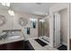 Bright bathroom featuring dual sinks, walk-in shower, and modern fixtures at 4212 W La Salle St, Tampa, FL 33607