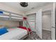 Bedroom featuring a bunk bed and an open closet with built-in organizers at 4212 W La Salle St, Tampa, FL 33607