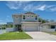 Charming two-story home features a well-maintained lawn, two-car garage, and a light blue exterior at 4212 W La Salle St, Tampa, FL 33607