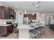 Spacious kitchen island with seating, dark cabinetry, stainless appliances and stylish pendant lighting at 4212 W La Salle St, Tampa, FL 33607