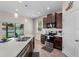 Beautiful kitchen with stainless steel appliances, an island sink, dark wood cabinets, and natural light at 4212 W La Salle St, Tampa, FL 33607