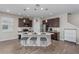Open kitchen with an island featuring bar seating, stainless steel appliances, and dark wood cabinets at 4212 W La Salle St, Tampa, FL 33607