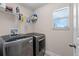 Laundry room with modern washer and dryer units and a window with natural light at 4212 W La Salle St, Tampa, FL 33607
