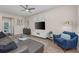 Stylish living room with modern furniture, a ceiling fan, wood-style flooring, and bright natural light at 4212 W La Salle St, Tampa, FL 33607