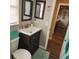Cozy bathroom with wood vanity, decorative mirrors and view to laundry area at 5119 Hector Ct, Tampa, FL 33624