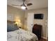 Comfortable bedroom featuring ceiling fan, television, and stylish furnishings at 5119 Hector Ct, Tampa, FL 33624