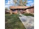 Charming brick home with a well-maintained lawn and concrete walkway leading to the front door at 5119 Hector Ct, Tampa, FL 33624