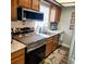 Well-lit kitchen with wooden cabinets, stainless steel appliances, and modern countertops at 5119 Hector Ct, Tampa, FL 33624