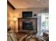 Spacious living room featuring a brick fireplace and sliding doors to the patio at 5119 Hector Ct, Tampa, FL 33624
