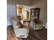 Open concept living room with reclining chairs and view to kitchen at 5119 Hector Ct, Tampa, FL 33624
