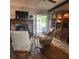 Living room featuring a brick fireplace, bookshelves and recliner chairs at 5119 Hector Ct, Tampa, FL 33624