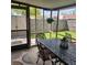 Relaxing screened porch with outdoor dining set overlooking the backyard at 5119 Hector Ct, Tampa, FL 33624