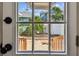 Backyard view through the glass paneled door highlighting the patio, landscaping, and neighboring homes at 535 6Th N St, St Petersburg, FL 33701
