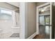 Traditional bathroom with white tile, patterned floor, shower-tub combo and hallway view at 535 6Th N St, St Petersburg, FL 33701