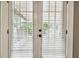 Close up view of the exterior doors with built-in blinds and hardware at 535 6Th N St, St Petersburg, FL 33701