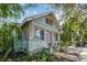 Charming home with a light blue exterior, purple door, and manicured landscaping at 535 6Th N St, St Petersburg, FL 33701