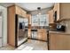 Well-lit kitchen featuring stainless steel appliances, wooden cabinets and tile backsplash at 535 6Th N St, St Petersburg, FL 33701