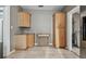 Kitchen with wooden cabinets, cart, and access to laundry room at 535 6Th N St, St Petersburg, FL 33701