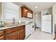 Bright kitchen with stainless sink, granite countertops, and white appliances at 535 6Th N St, St Petersburg, FL 33701