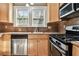Kitchen with stainless steel appliances and wooden cabinets, with natural light at 535 6Th N St, St Petersburg, FL 33701
