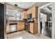 Kitchen featuring stainless steel appliances, wooden cabinets, and view into the living room at 535 6Th N St, St Petersburg, FL 33701