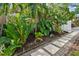 Beautifully landscaped walkway surrounded by lush tropical foliage and plants at 535 6Th N St, St Petersburg, FL 33701