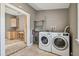 Laundry room with new washer and dryer units, tile floor, and view into kitchen at 535 6Th N St, St Petersburg, FL 33701