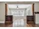 Bright living room featuring hardwood floors, built-in bookshelves, and large windows with natural light at 535 6Th N St, St Petersburg, FL 33701