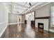 Spacious living room with dark hardwood floors, coffered ceilings, a fireplace, and an open layout at 535 6Th N St, St Petersburg, FL 33701
