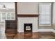 Close up of a fireplace with a white mantel and tiled floors in a large living room with hardwood floors at 535 6Th N St, St Petersburg, FL 33701