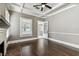 Living room featuring hardwood floors, coffered ceilings, a white fireplace, and a view of the sun room at 535 6Th N St, St Petersburg, FL 33701