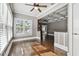 Cozy living room features hardwood floors, neutral walls, large windows, and modern ceiling fan at 535 6Th N St, St Petersburg, FL 33701