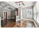 Living room boasts hardwood floors, neutral walls, large windows, and modern ceiling fan at 535 6Th N St, St Petersburg, FL 33701