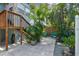 A peaceful patio area with pavers, tropical plants, and two Adirondack chairs at 535 6Th N St, St Petersburg, FL 33701