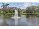 Pond with a fountain surrounded by lush greenery and trees on a sunny day at 535 6Th N St, St Petersburg, FL 33701