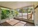 Screened-in porch featuring wood floors, access to a landscaped backyard, and lush surroundings at 535 6Th N St, St Petersburg, FL 33701