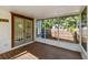 Screened-in porch with wood flooring overlooking a wooden fence and lush foliage at 535 6Th N St, St Petersburg, FL 33701