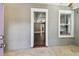 Bright sun room with tile floors and a view of the living room with hardwood floors and coffered ceilings at 535 6Th N St, St Petersburg, FL 33701