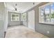 Bright sun room featuring neutral walls, tiled flooring, and plenty of natural light from multiple windows at 535 6Th N St, St Petersburg, FL 33701