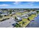 An aerial shot of a waterfront property featuring a dock, well-kept lawn, and coastal community at 551 Lindley Ter, Port Charlotte, FL 33952
