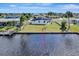 Waterfront backyard features a well-maintained lawn, dock access, and outdoor seating, ideal for relaxation and entertainment at 551 Lindley Ter, Port Charlotte, FL 33952