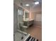 Bathroom featuring a glass shower enclosure, illuminated mirror and updated vanity at 551 Lindley Ter, Port Charlotte, FL 33952