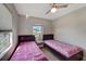 Comfortable bedroom with two twin beds, tile flooring, and a bright window providing natural light and serene views at 551 Lindley Ter, Port Charlotte, FL 33952